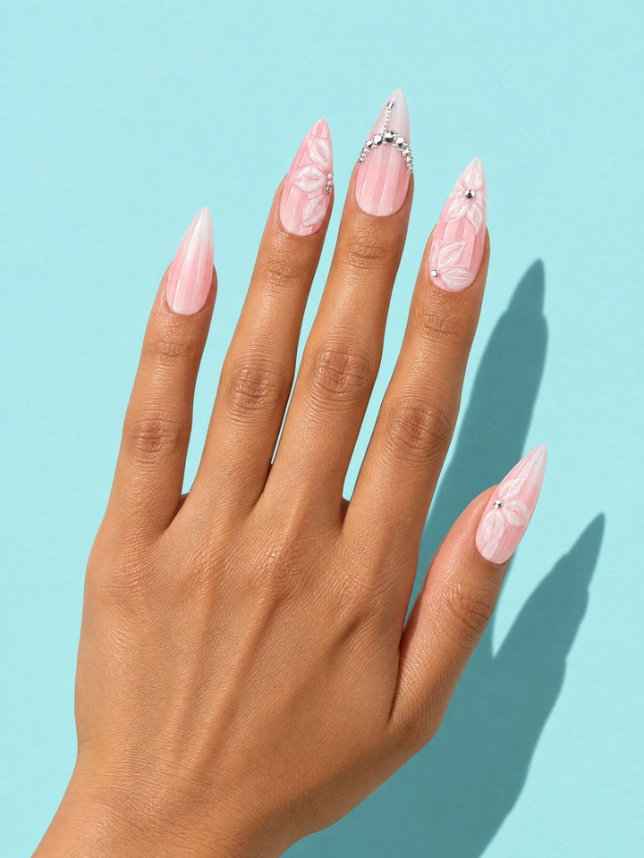 Pink Marble Rhinestone Stiletto Press-On Nails on a hand