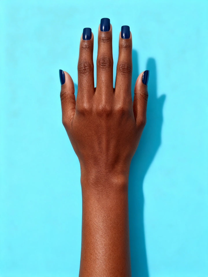 Navy press-on nails on a hand