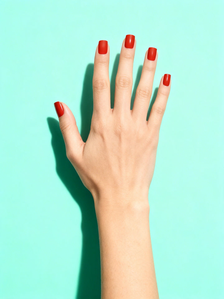 Tomato Red press-on nails on a hand