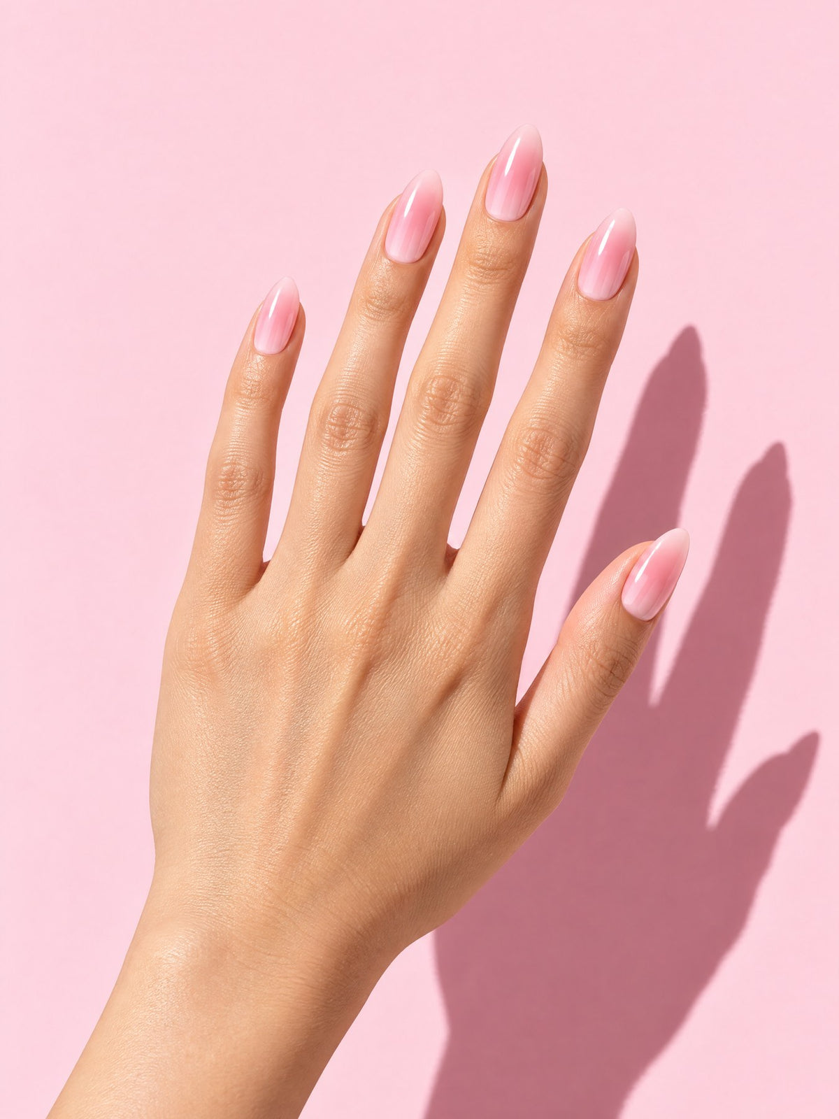 Blush Gradient Almond Press-On Nails on a hand