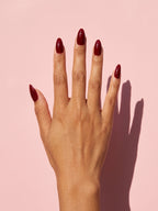 Wine Red Almond Press-On Nails on a hand