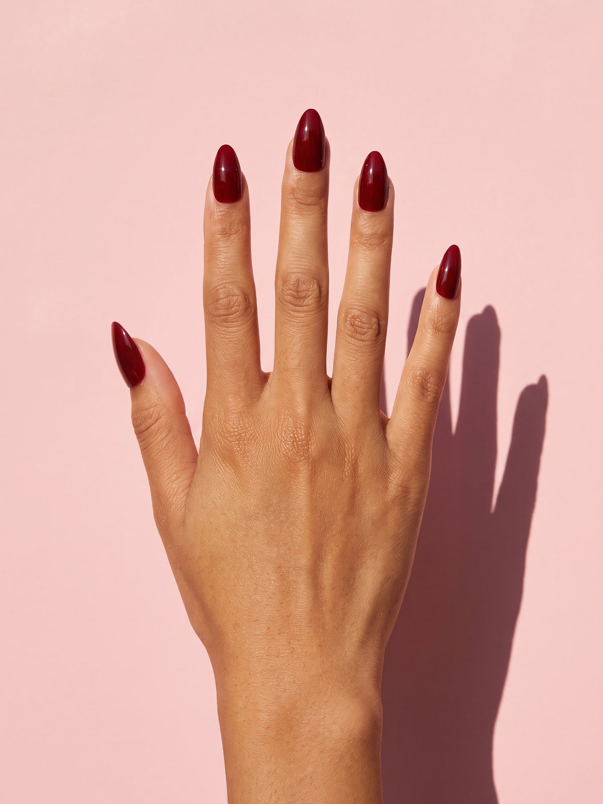 Wine Red Almond Press-On Nails on a hand