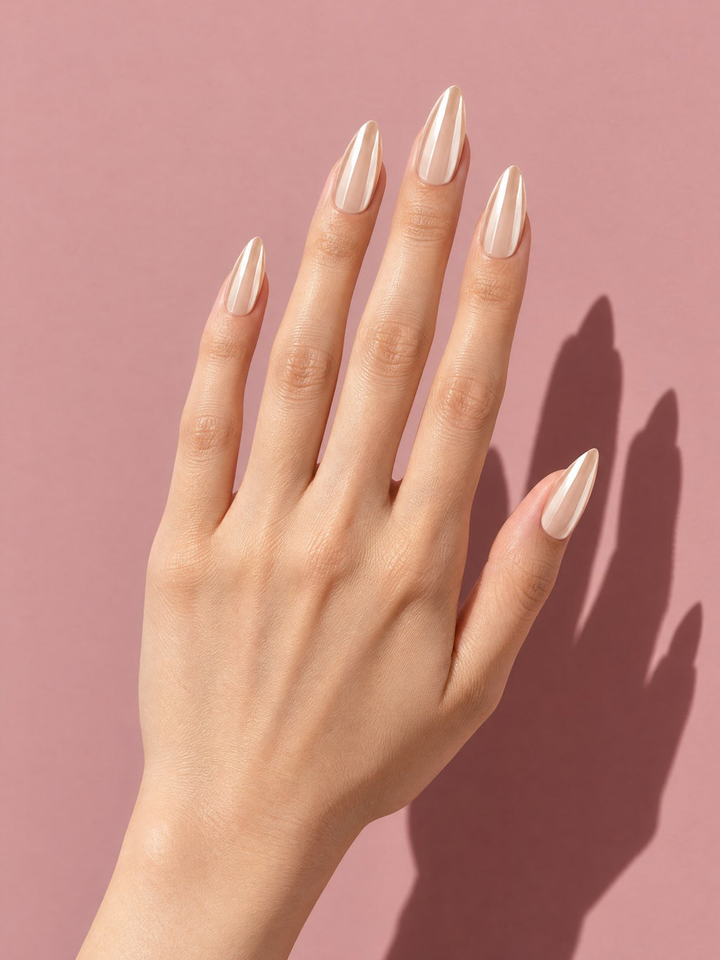 Champagne Pearl Chrome Almond Press-On Nails on a hand