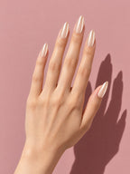 Champagne Pearl Chrome Almond Press-On Nails on a hand