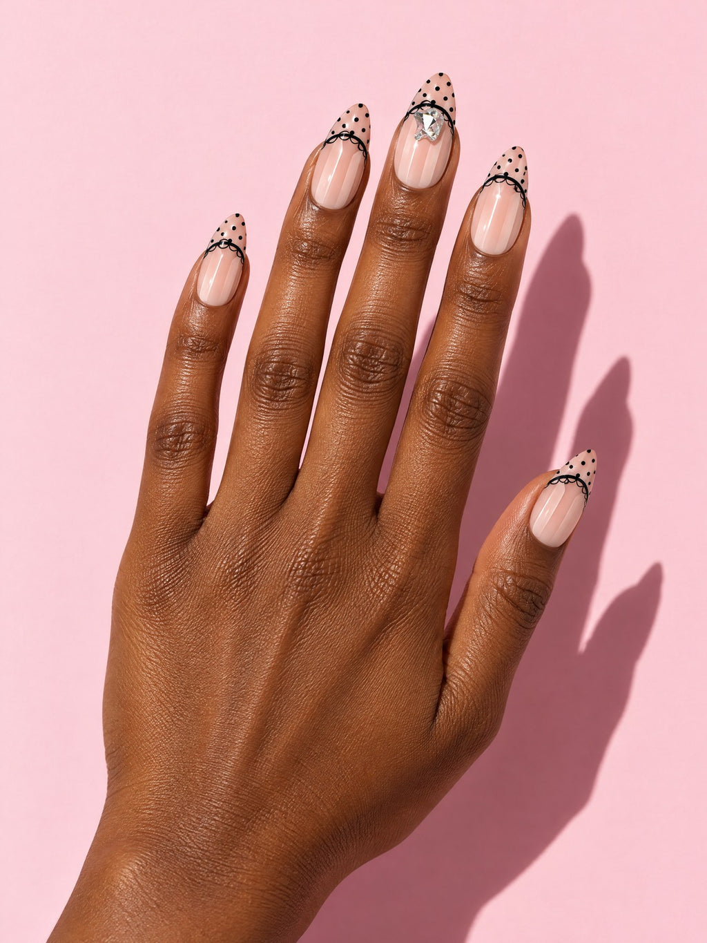 Black Dot French Almond Press-On Nails on a hand
