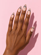 Black Dot French Almond Press-On Nails on a hand