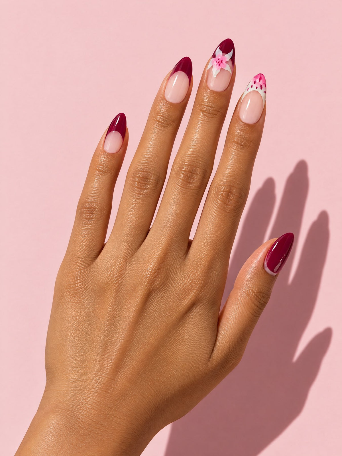 Burgundy Floral French Almond Press-On Nails on a hand