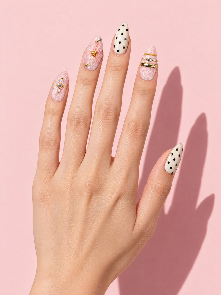 Polka Dot Bow & Blossom Almond Press-On Nails on a hand
