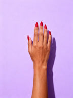 Classic Red press-on nails on a hand