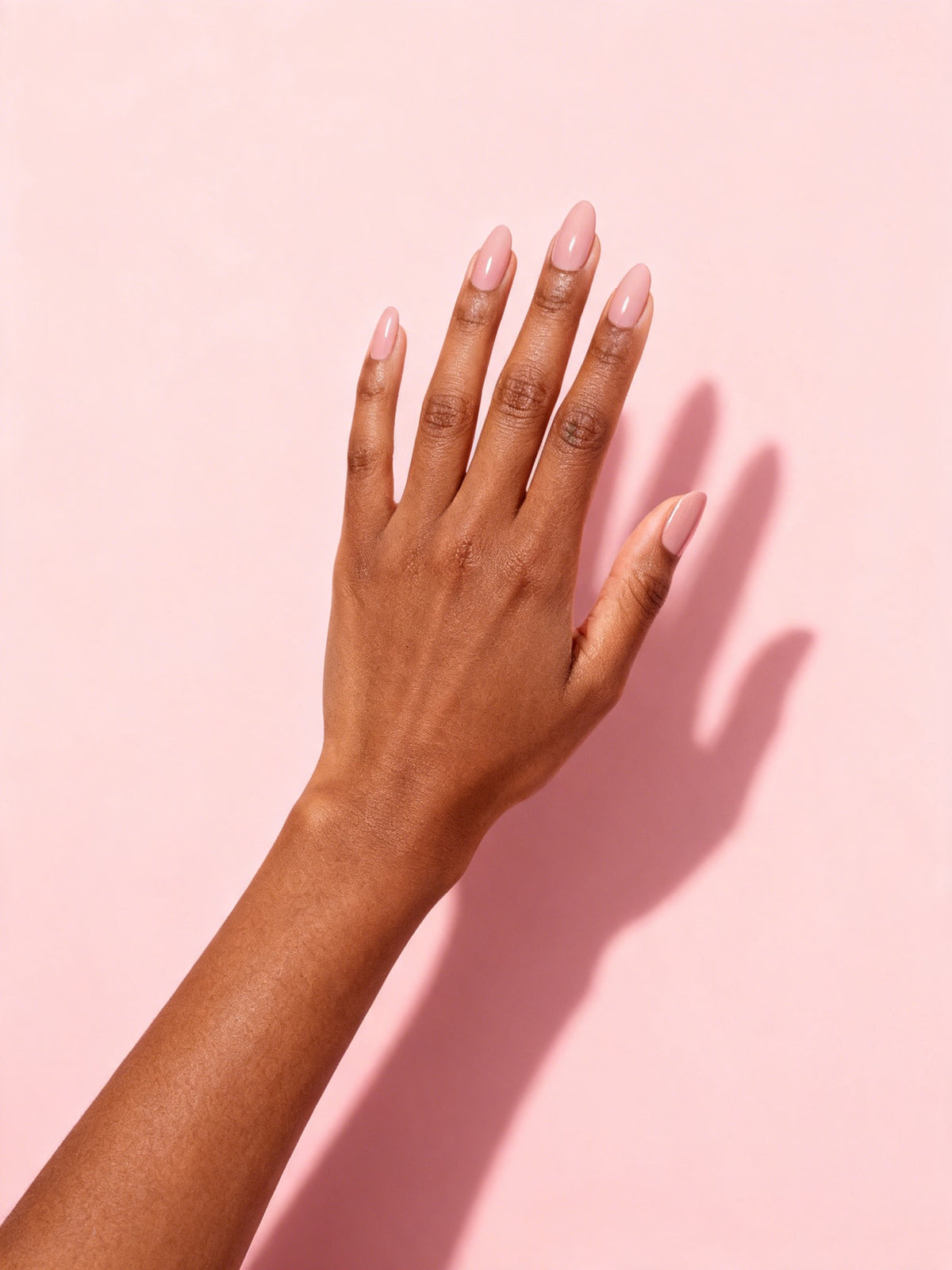 Nude Pink press-on nails on a hand