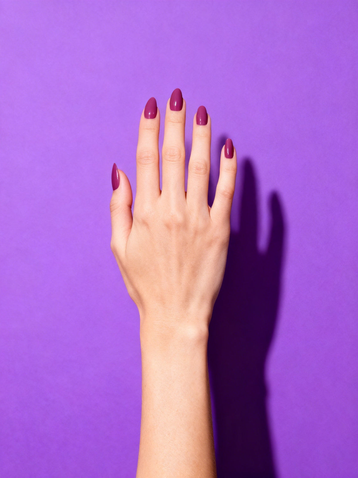 Plum Rose press-on nails on a hand