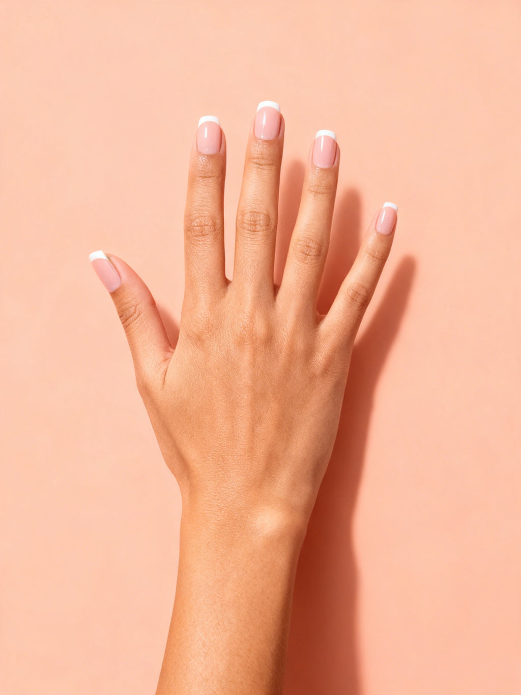 Nude Micro French Short Press-On Nails on a hand