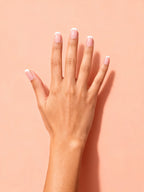 Nude Micro French Short Press-On Nails on a hand