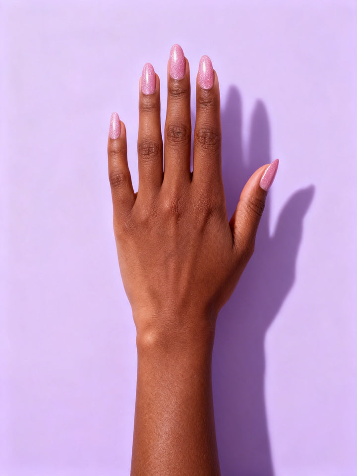 Pink Shimmer Almond Press-On Nails on a hand