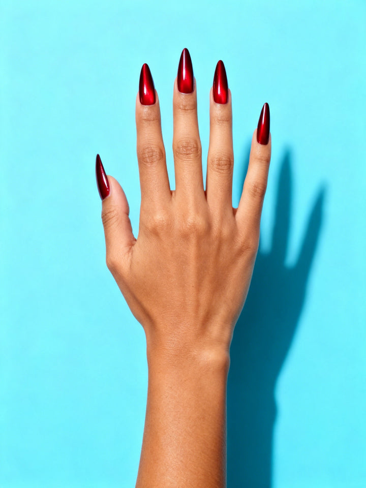 Red Chrome Stiletto Press-On Nails on a hand