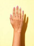 Red Polka Dot Almond Press-On Nails on a hand