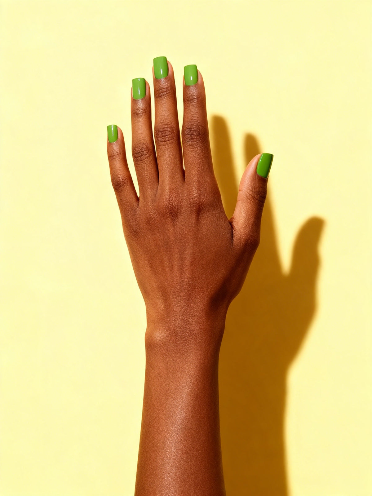 Apple Green press-on nails on a hand