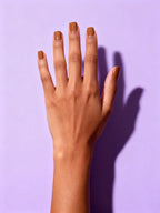 Caramel press-on nails on a hand