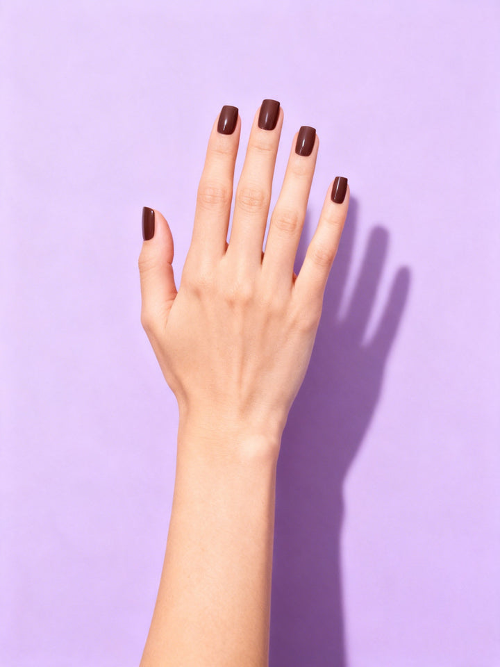 Espresso press-on nails on a hand