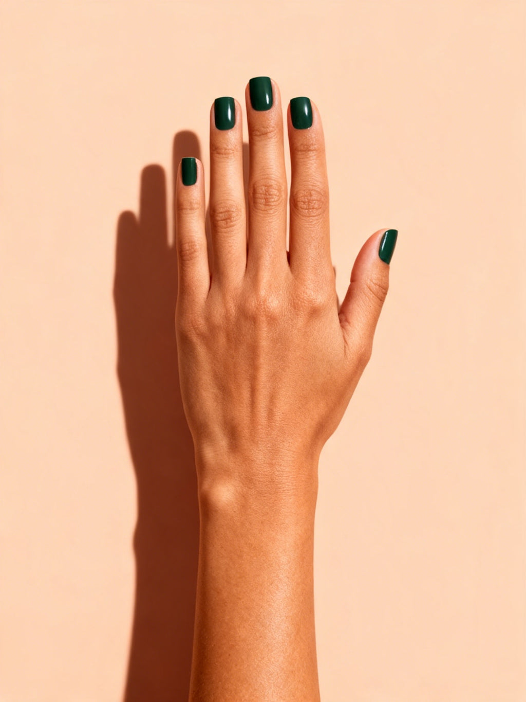 Emerald Green press-on nails on a hand