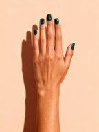 Emerald Green press-on nails on a hand