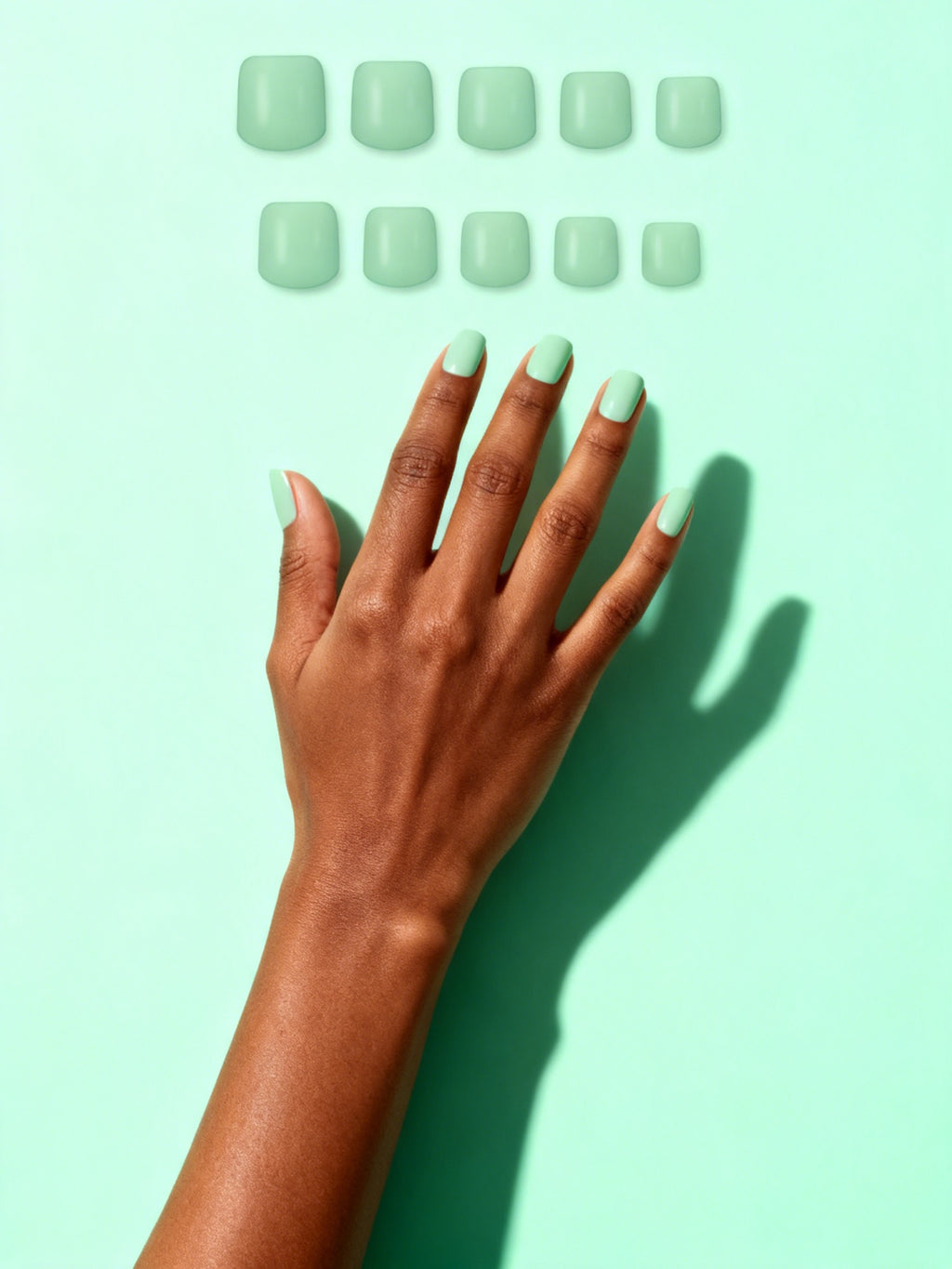 Sage press-on nails on a hand