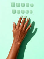 Sage press-on nails on a hand
