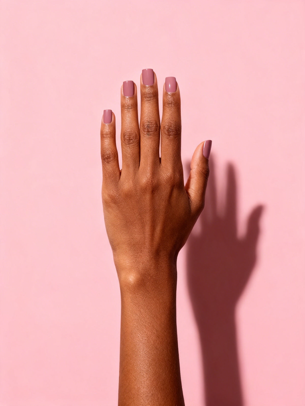 Dusty Rose press-on nails on a hand