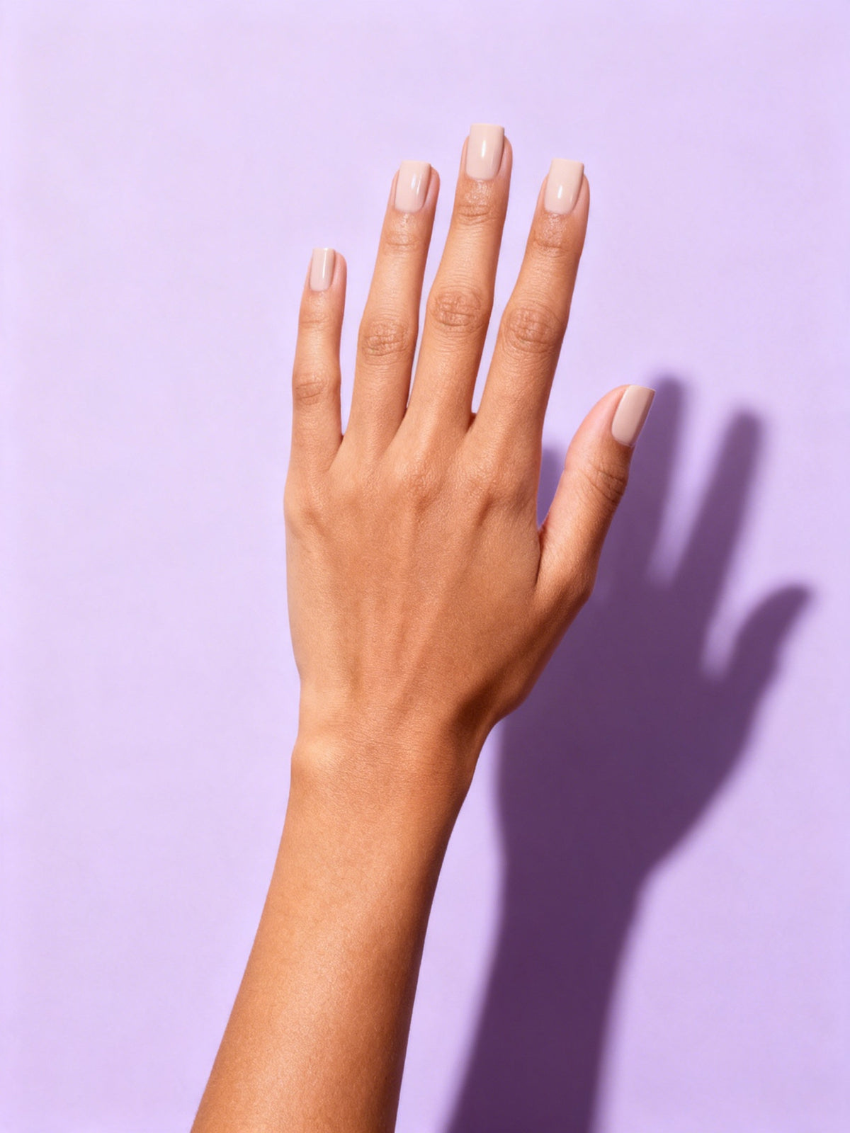 Nude Beige press-on nails on a hand