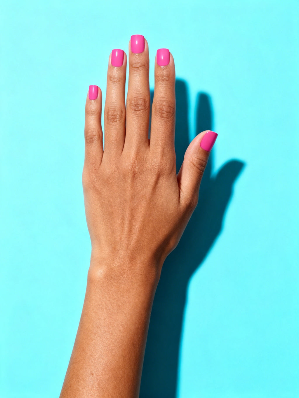 Hot Pink press-on nails on a hand