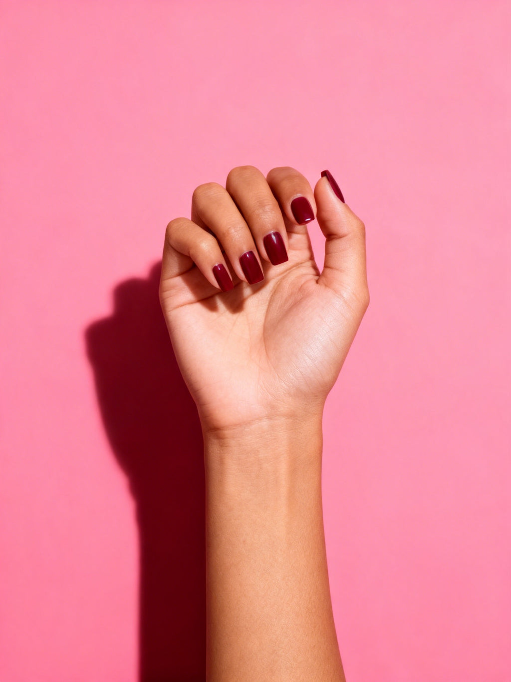 Cherry Burgundy press-on nails on a hand